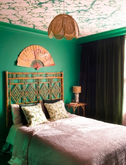 The marbled ceiling created curtesy of P&B wallpaper, Margate Marble in Emerald Pinky, bamboo bedhead, bedside table, lampshade and fan all come together to provide the Chinese theme Whinnie was inspired to create in this bedroom.