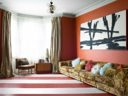 ‘Nothing in this house has really been bought new, it is more of a challenge and much more fun that everything has a story.’ The stripy Forbo vinyl flooring comes in a range of colours. Cushions from P&B can be seen on the vintage 1970s eBay sofa alongside the mid-century chair and cabinet.