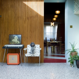 Brian at home on a P&B upholstered vintage chair. The terrazzo flooring was inspired by a hairdresser in Venice.