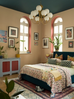 Tom Bax's bedroom, Farrow & Ball's Setting Plaster Pink is on the walls and F&B's Drawing Room Red has been painted inside the ornate window arches with Hague Blue on the ceiling.